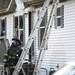 Firefighters prepare to re-enter the house. Daniel Brenner I AnnArbor.com